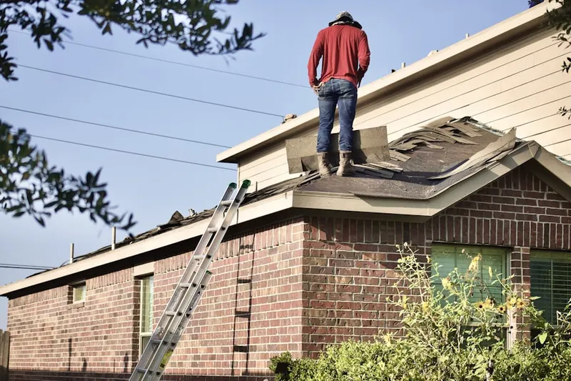 Professional roofer working on a residential roof in Westside Neighborhood